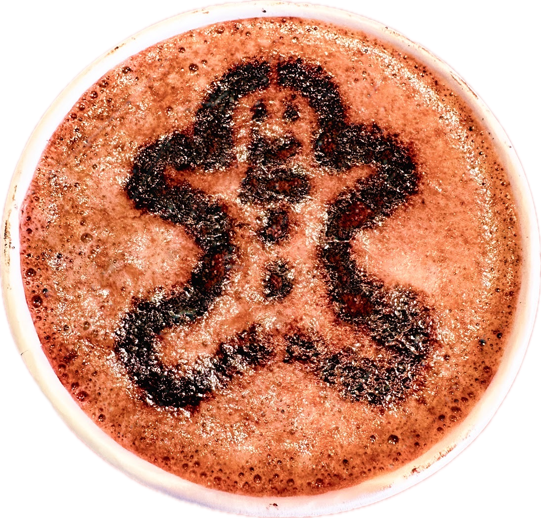 A hot chocolate topped with a gingerbread man stencilled in cocoa on the foam, shot from directly above